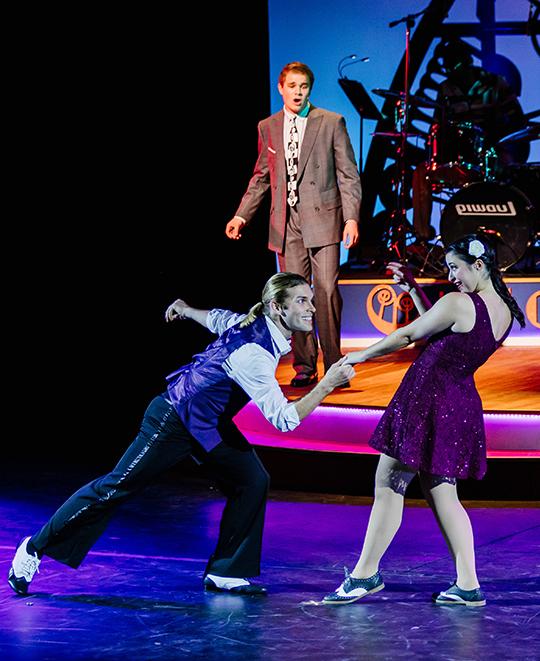 Students perform on stage during a rehearsal of Swing